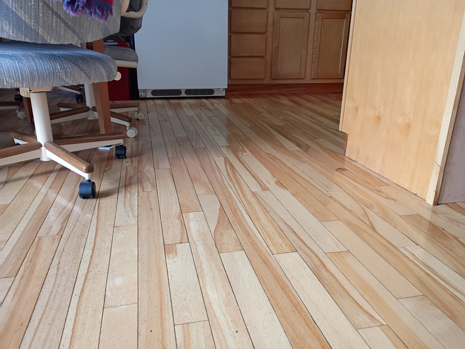Clean wood floor beneath office chairs after a room reset